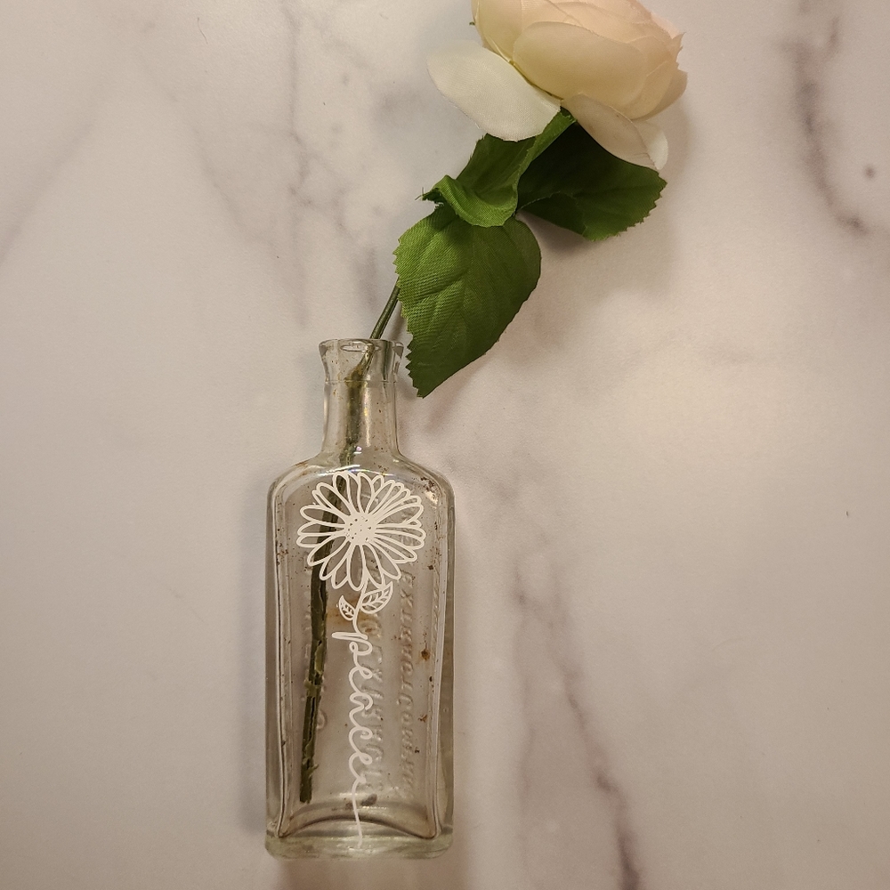 Antique bottle with vinyl art
